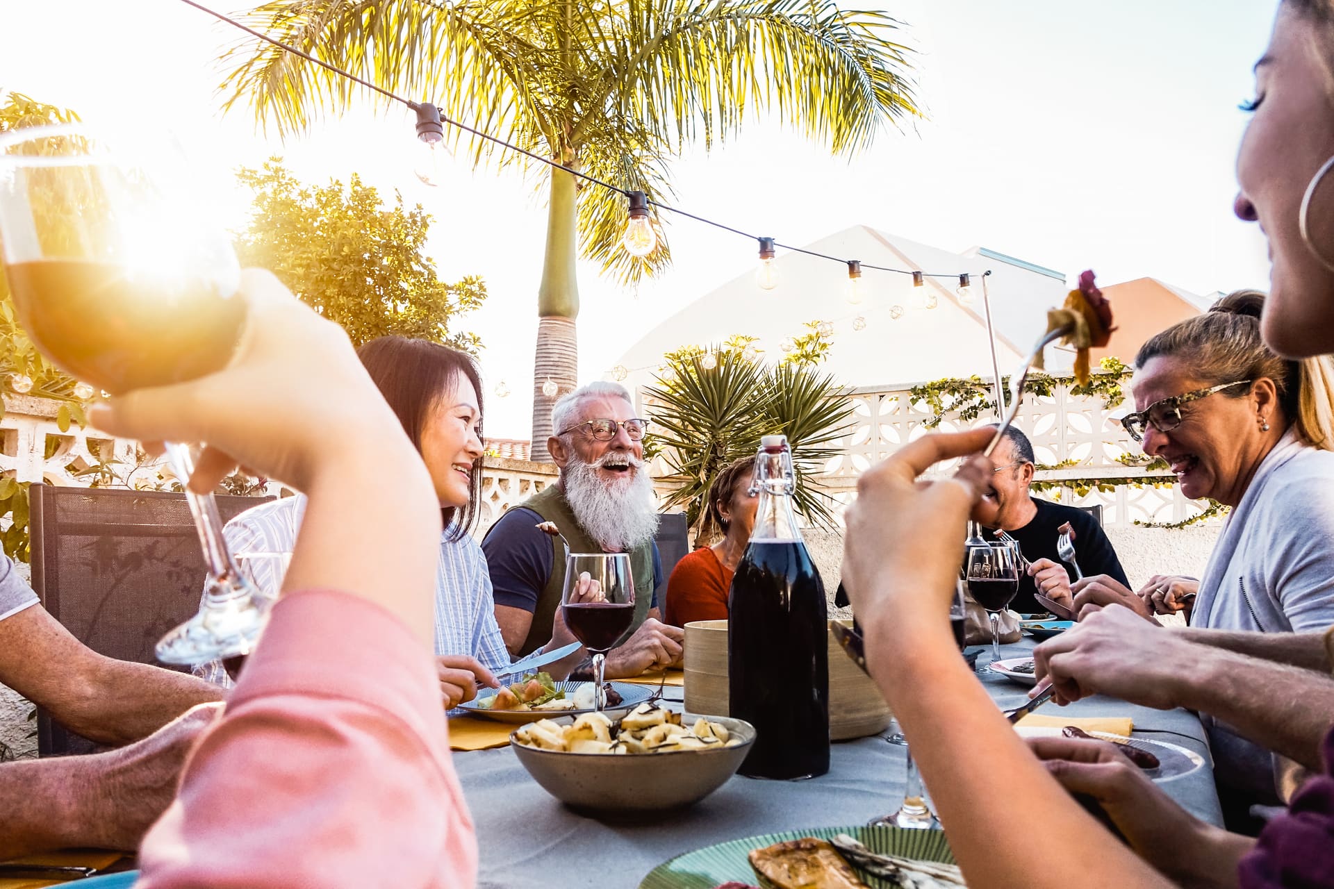 Outdoor dining under palm trees in South Florida — protected from mosquitoes by Mosquito Shield