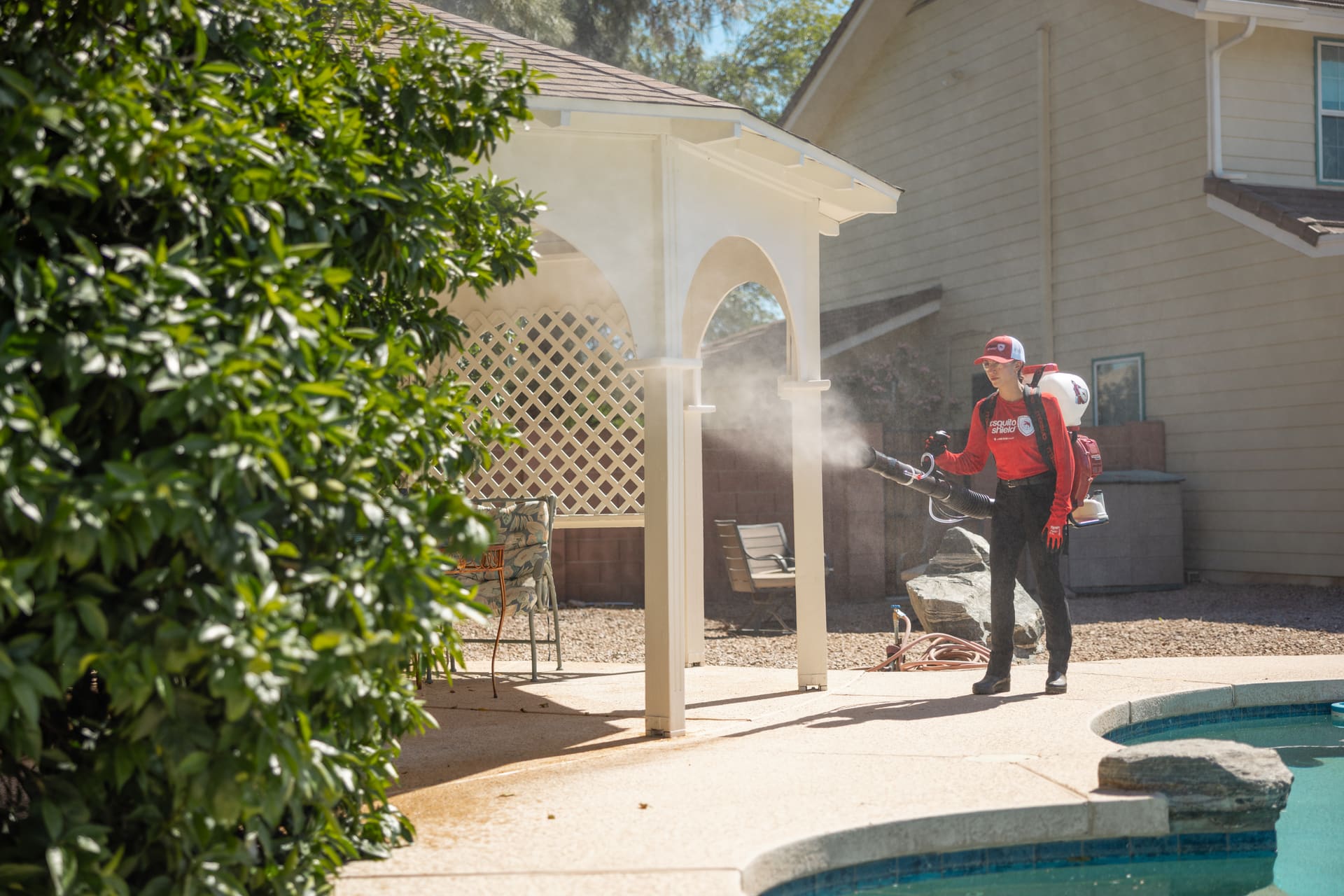 Mosquito Shield technician treating a luxury South Florida waterfront property